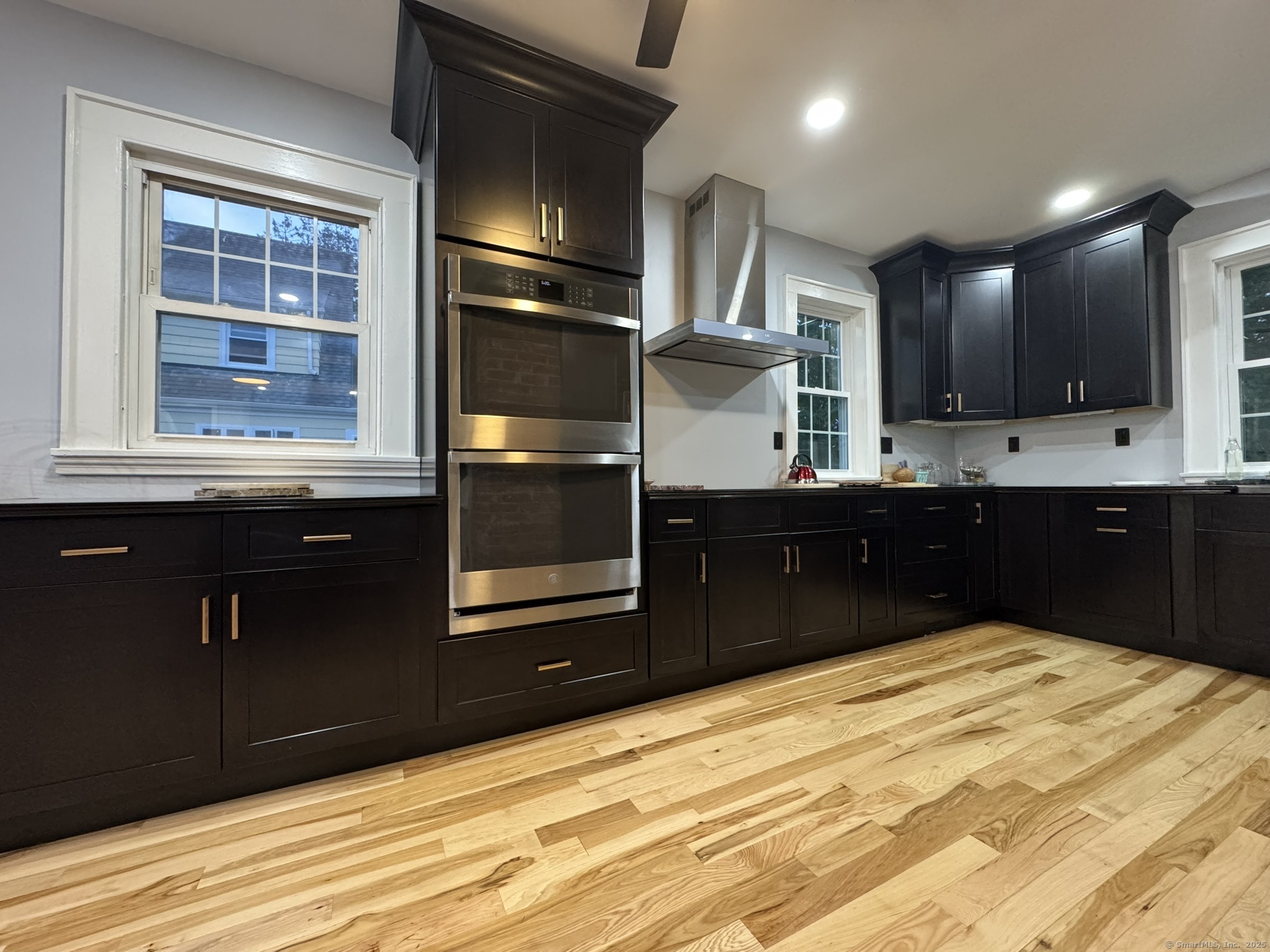 127 Lambert Avenue Meriden, CT 06451 - Photo 9 of 37 a kitchen with a wooden floor and cabinets