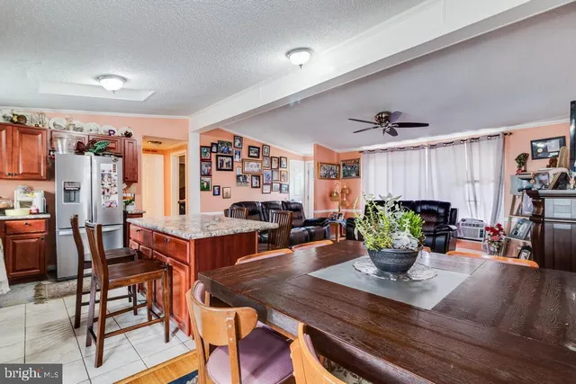 a living room with dining room and wooden floor