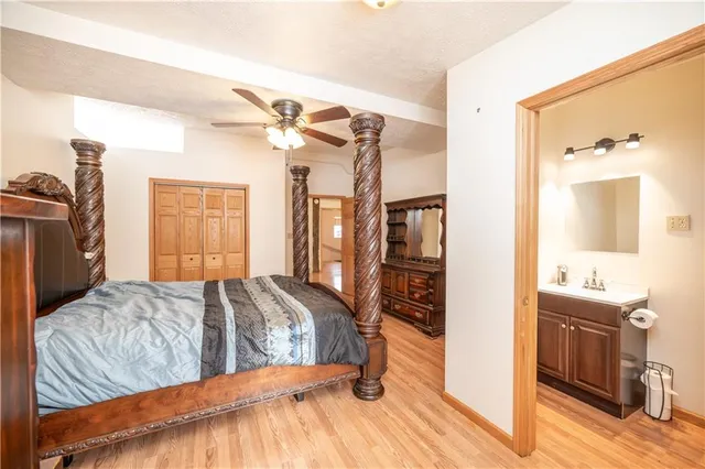 a bedroom with a bed and a mirror on the dresser