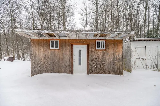 a view of a house with a snow in the yard