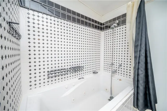 a bathroom with a bathtub and shower