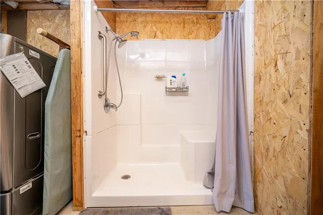 a bathroom with a glass shower door