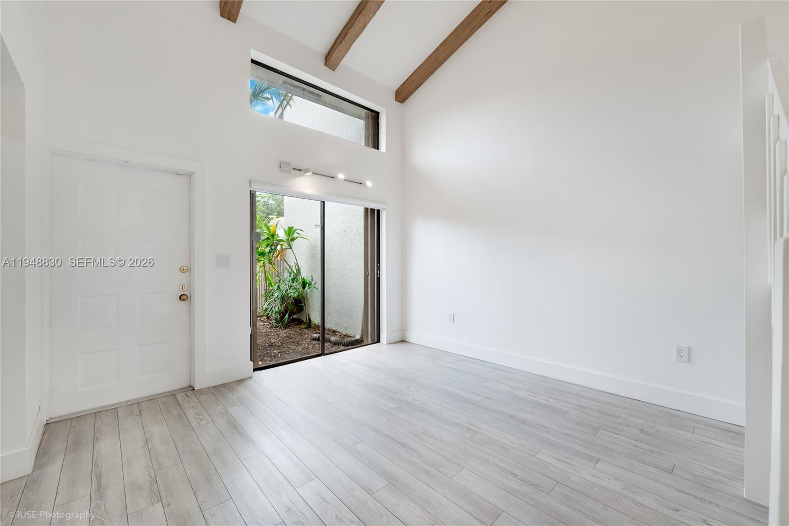 11416 Southwest 110th Lane Miami, FL 33176 - Photo 11 of 25 wooden floor in an empty room with a window