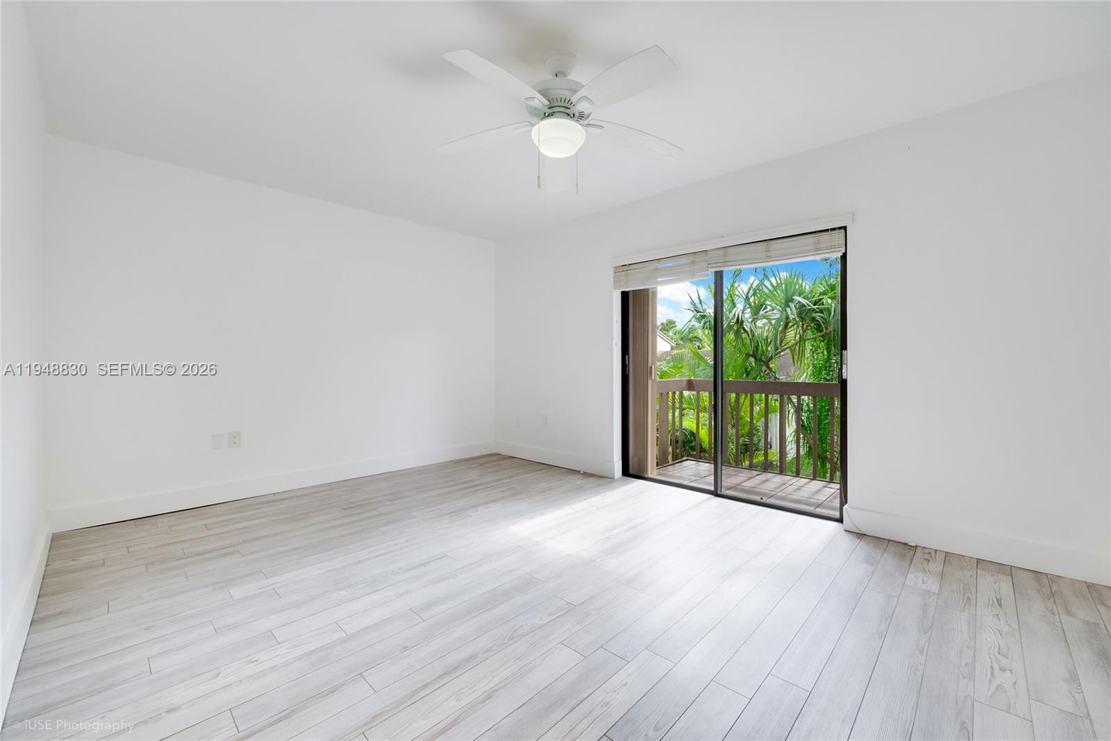 11416 Southwest 110th Lane Miami, FL 33176 - Photo 12 of 25 an empty room with wooden floor and windows