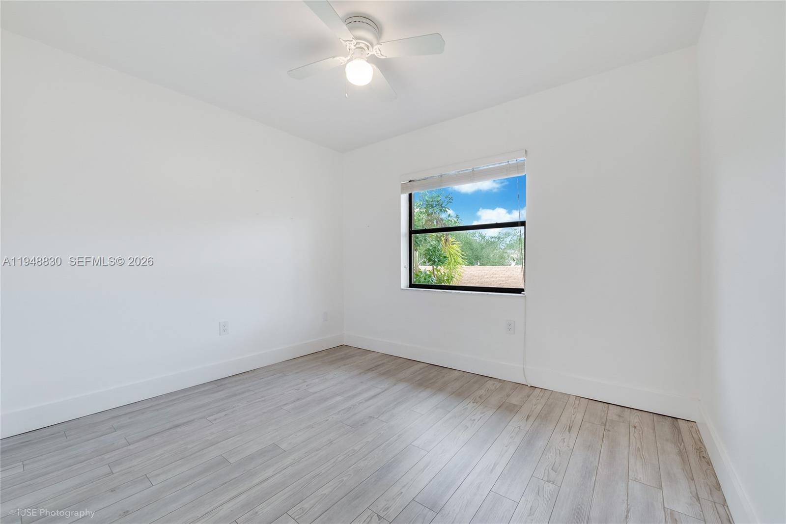 11416 Southwest 110th Lane Miami, FL 33176 - Photo 14 of 25 an empty room with wooden floor and windows