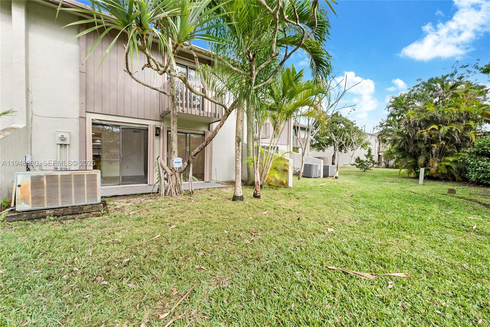 11416 Southwest 110th Lane Miami, FL 33176 - Photo 15 of 25 a backyard of a house with table and chairs