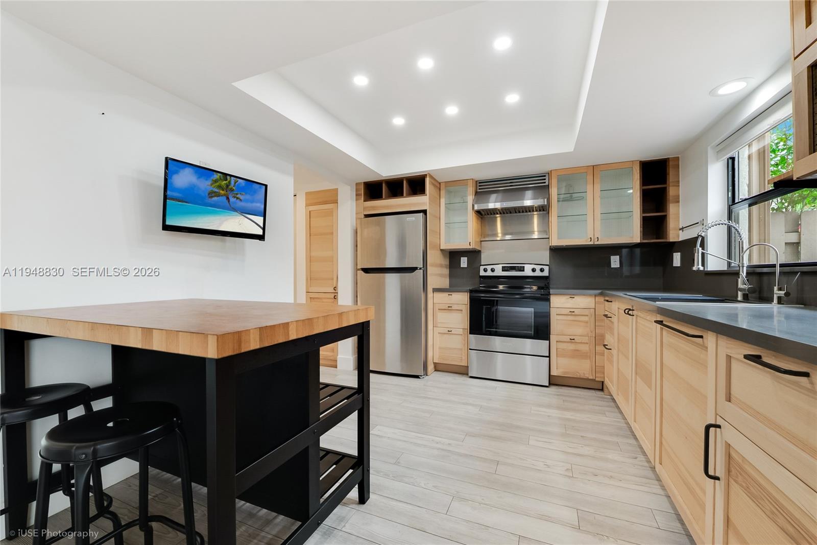 11416 Southwest 110th Lane Miami, FL 33176 - Photo 5 of 25 a kitchen with stainless steel appliances granite countertop a stove a sink dishwasher and a refrigerator with wooden floor