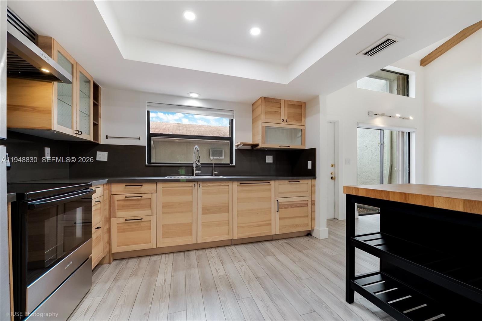 11416 Southwest 110th Lane Miami, FL 33176 - Photo 6 of 25 a kitchen with stainless steel appliances granite countertop a stove a sink and white cabinets
