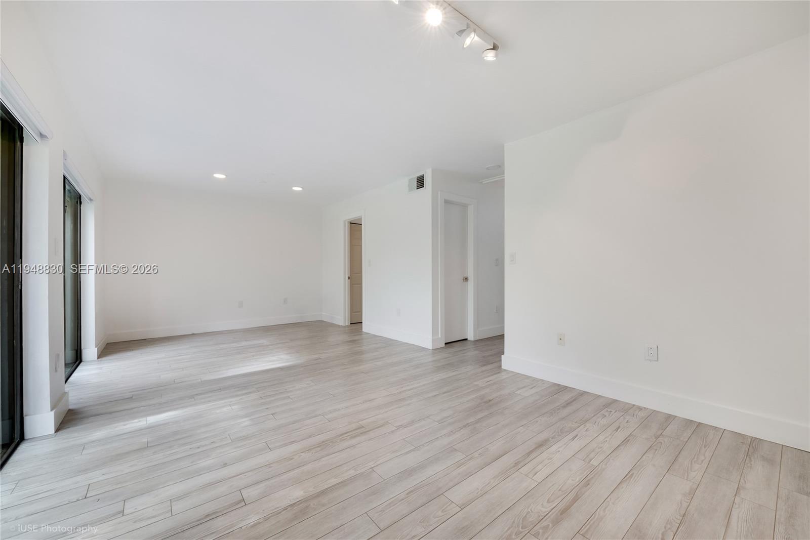 11416 Southwest 110th Lane Miami, FL 33176 - Photo 9 of 25 a view of an empty room with wooden floor
