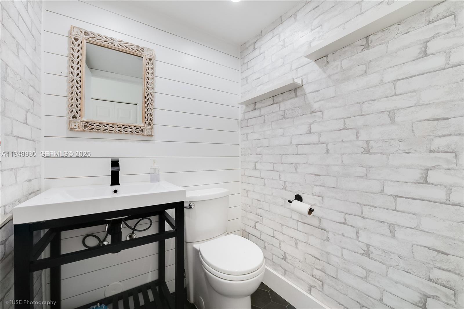 11416 Southwest 110th Lane Miami, FL 33176 - Photo 10 of 25 a bathroom with a toilet a sink and mirror