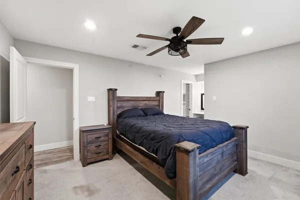 a bed room with a bed and a ceiling fan