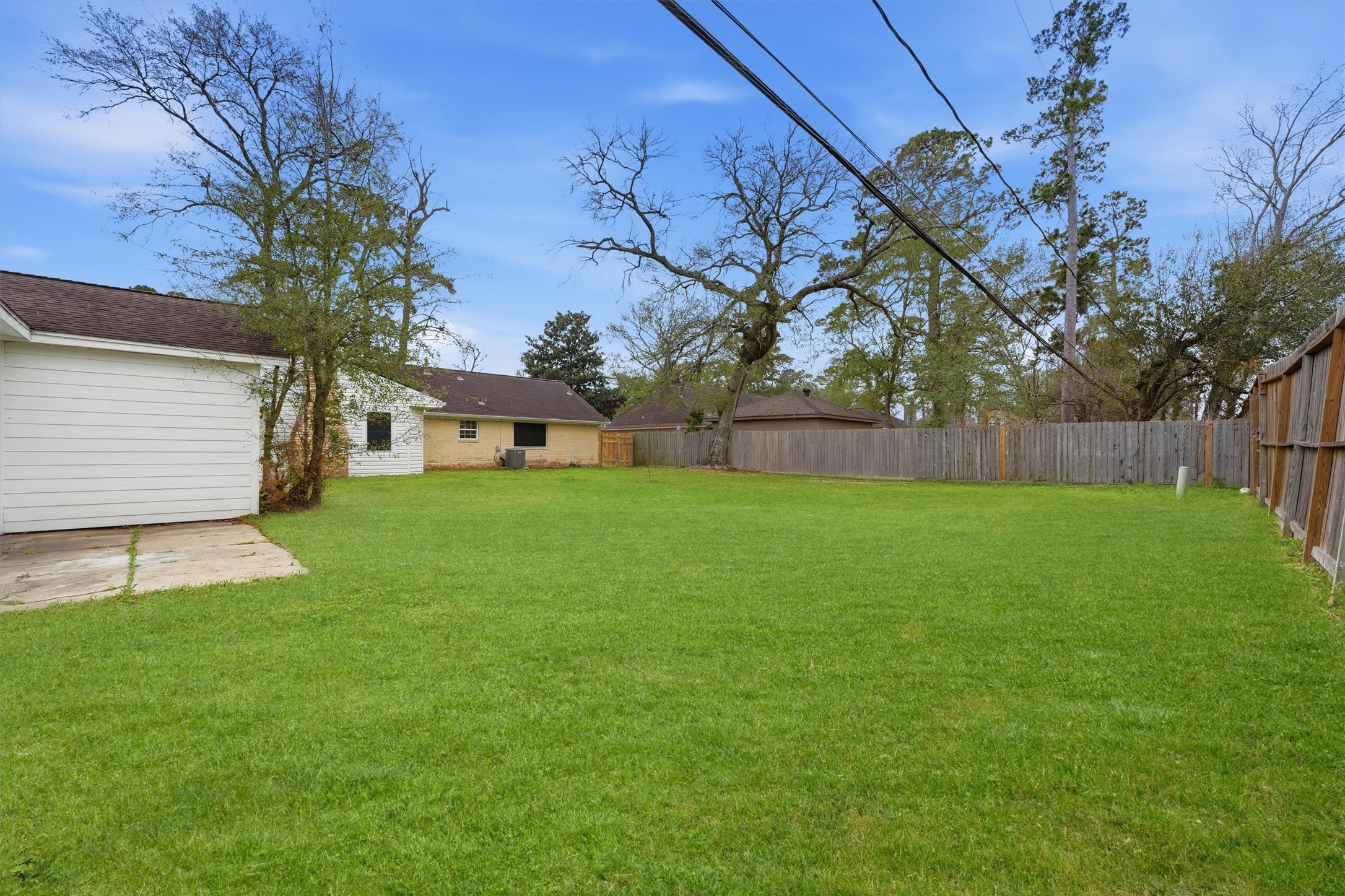 431 Dover Lane Spring, TX 77373 - Photo 18 of 19 a view of a backyard with a small cabin