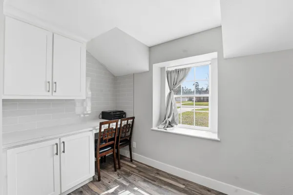 a view of room with window and furniture