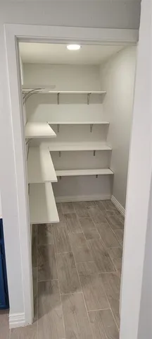 a view of walk in closet with empty racks