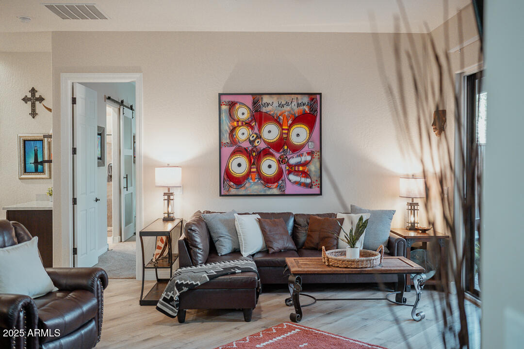 3835 Portofino Way Sedona, AZ 86336 - Photo 12 of 48 a living room with furniture and a painting on the wall
