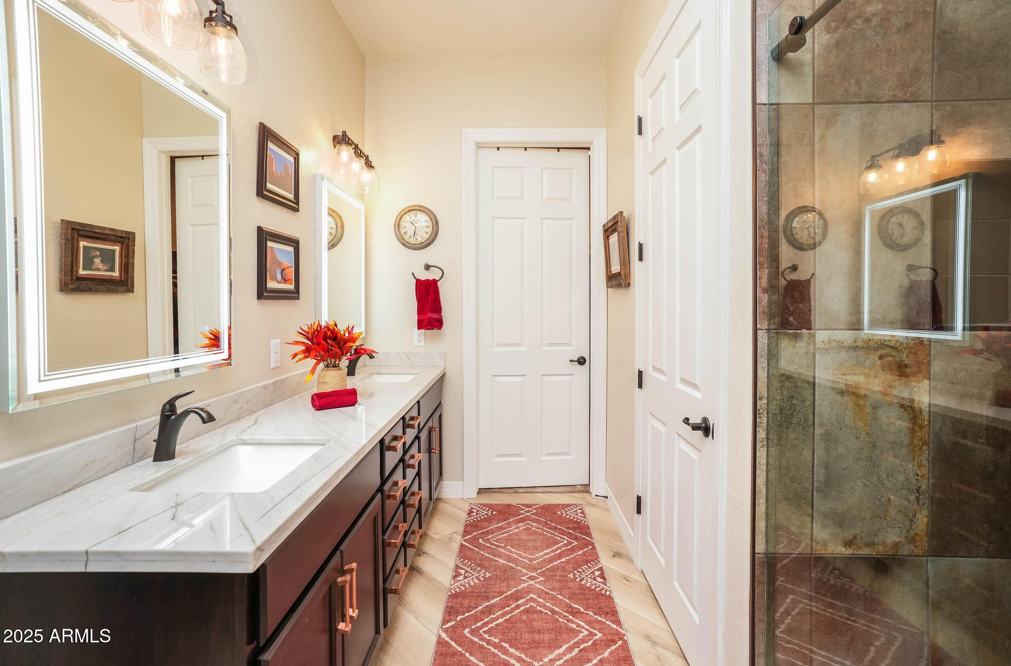 3835 Portofino Way Sedona, AZ 86336 - Photo 19 of 48 a bathroom with a sink vanity granite shower and a mirror