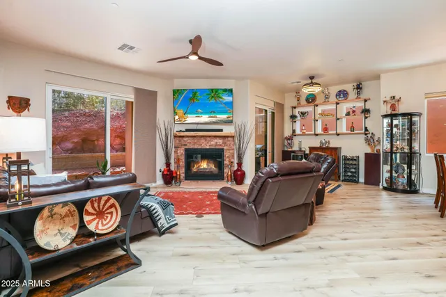 a large kitchen with stainless steel appliances a stove a sink a dining table and chairs with wooden floor