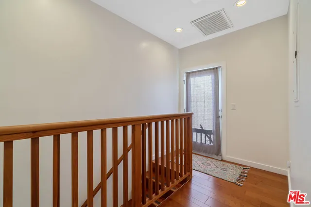 a bedroom with a bed window and a potted plant
