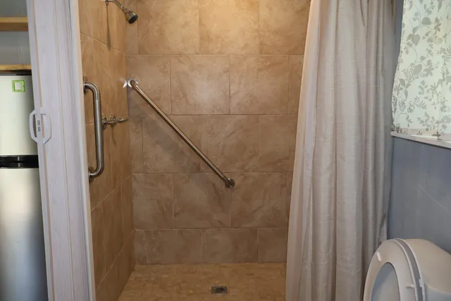 a bathroom with a shower and a window