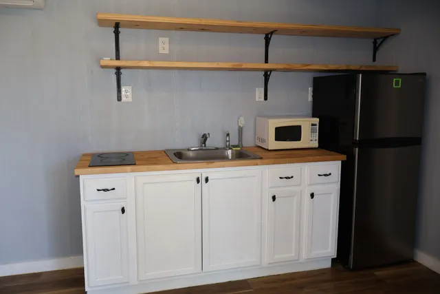 a kitchen with a refrigerator and cabinets