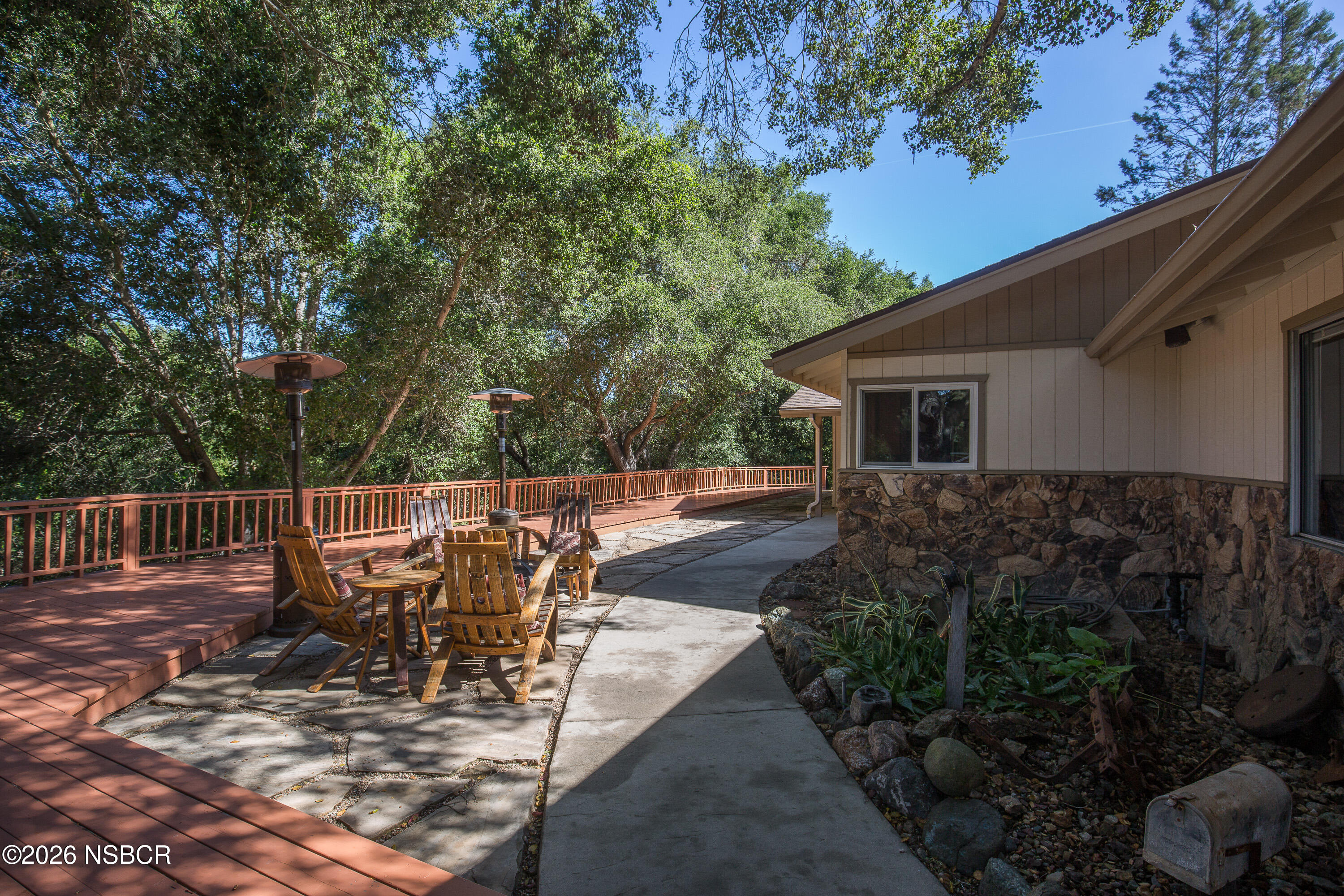 a view of a patio with table and chairs potted plants with wooden fence