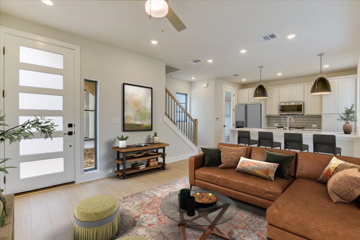 a living room with furniture and a chandelier