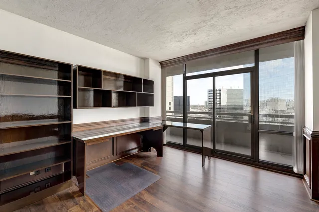 a view of a room with wooden floor and windows