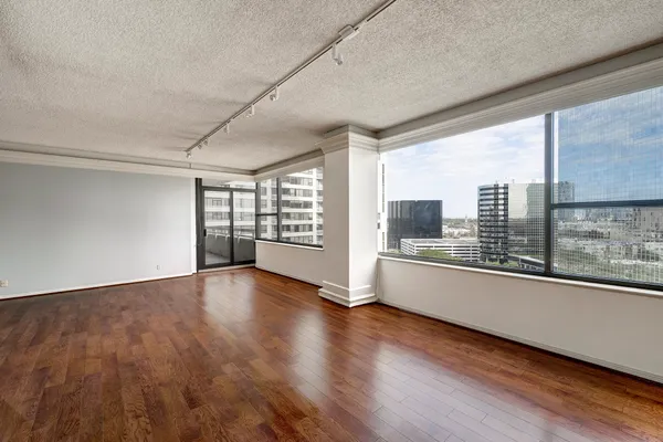 a large room with wooden floor and windows