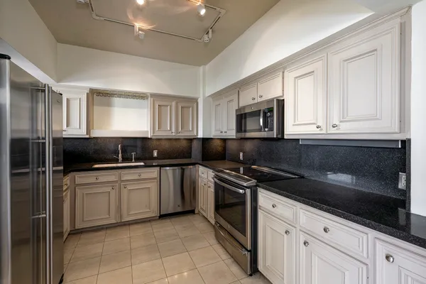 a kitchen with a sink stove and microwave