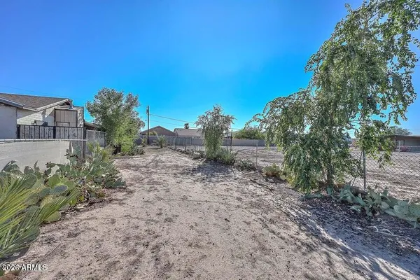 a view of a yard with a house in the background