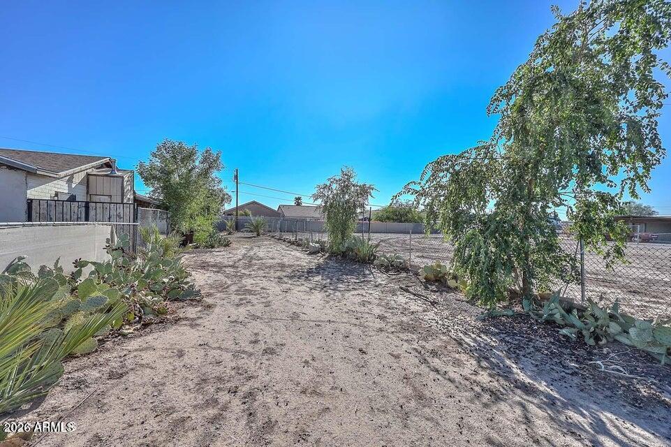 3339 West Washington Street, Unit 2 Phoenix, AZ 85009 - Photo 1 of 5 a view of a yard with a house in the background