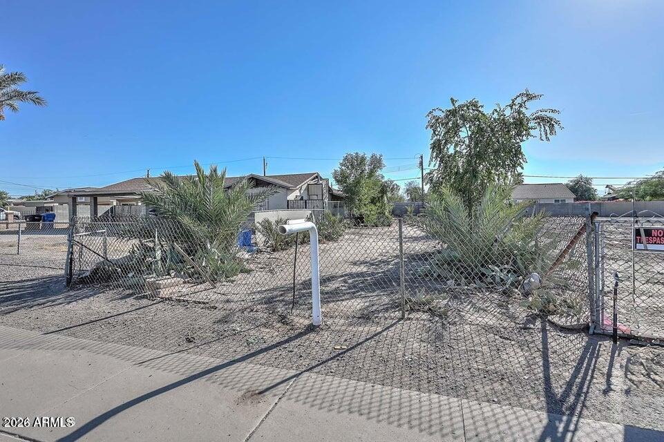 3339 West Washington Street, Unit 2 Phoenix, AZ 85009 - Photo 5 of 5 a view of a dry yard with trees