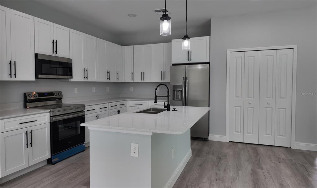 7 Spring Pass Ocala, FL 34472 - Photo 24 of 35 a kitchen with stainless steel appliances a sink stove and refrigerator