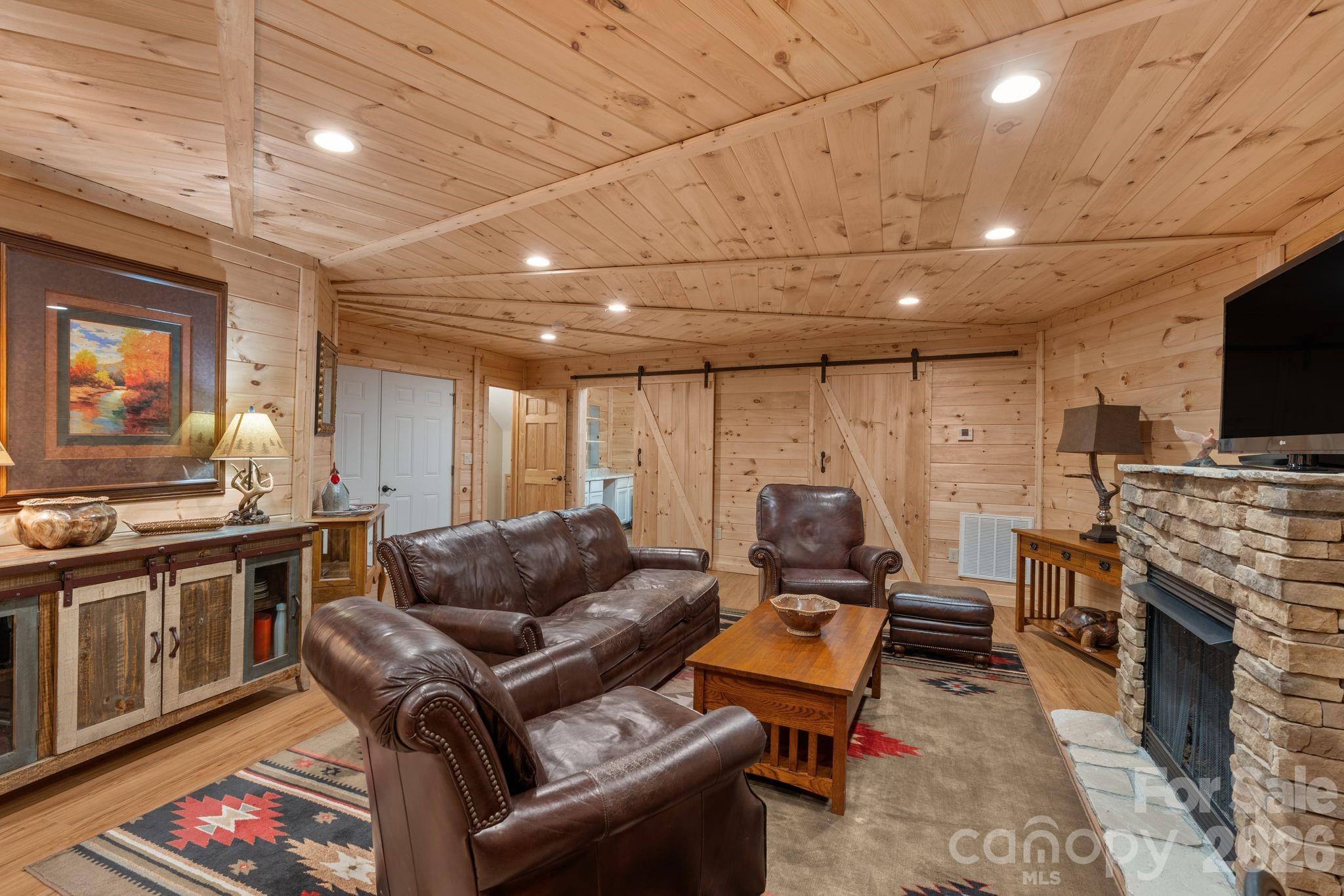 140 Slim Ridge Maggie Valley, NC 28751 - Photo 16 of 33 a living room with furniture a flat screen tv and a fireplace