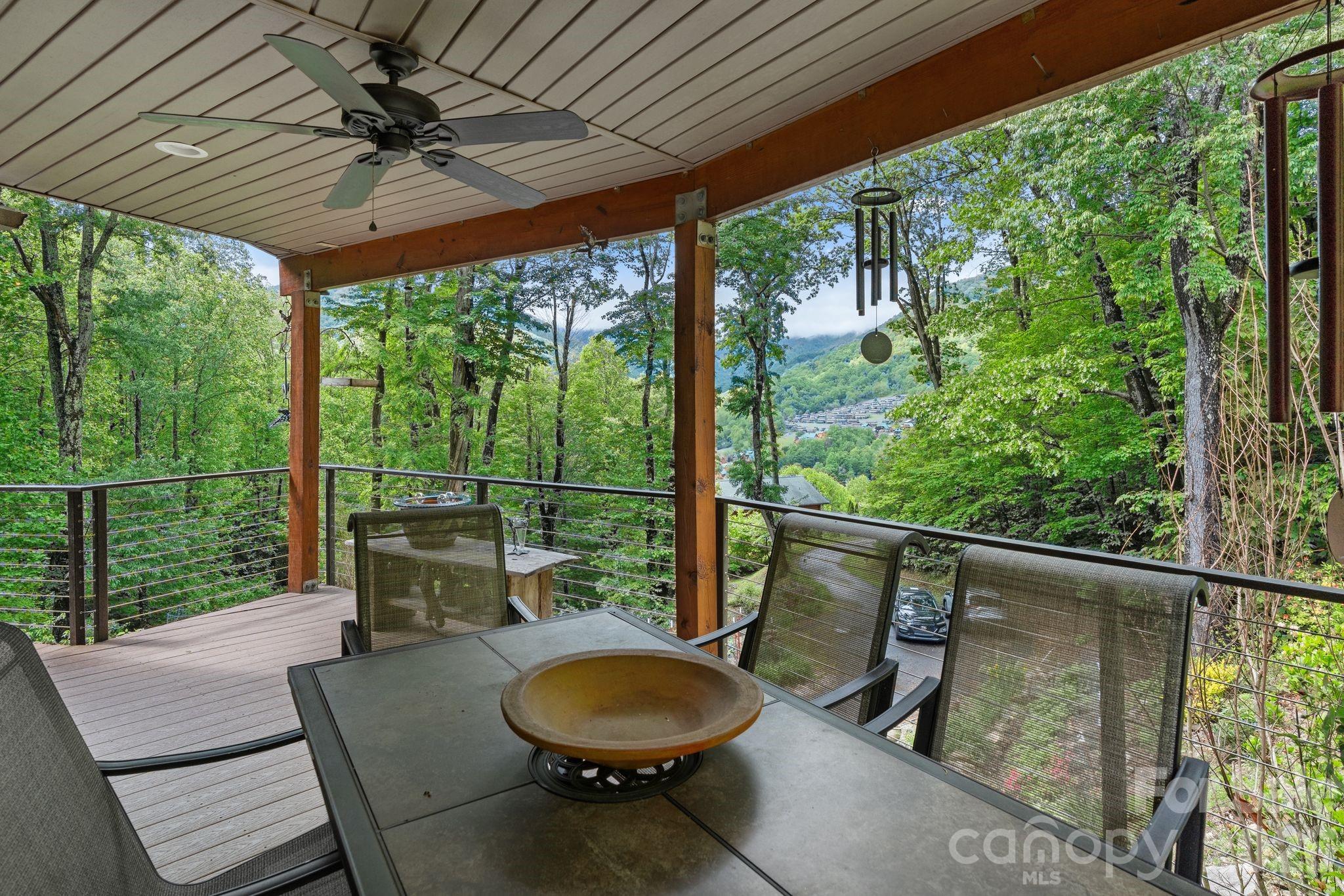 140 Slim Ridge Maggie Valley, NC 28751 - Photo 3 of 33 a backyard of a house with wooden floor outdoor seating and nature