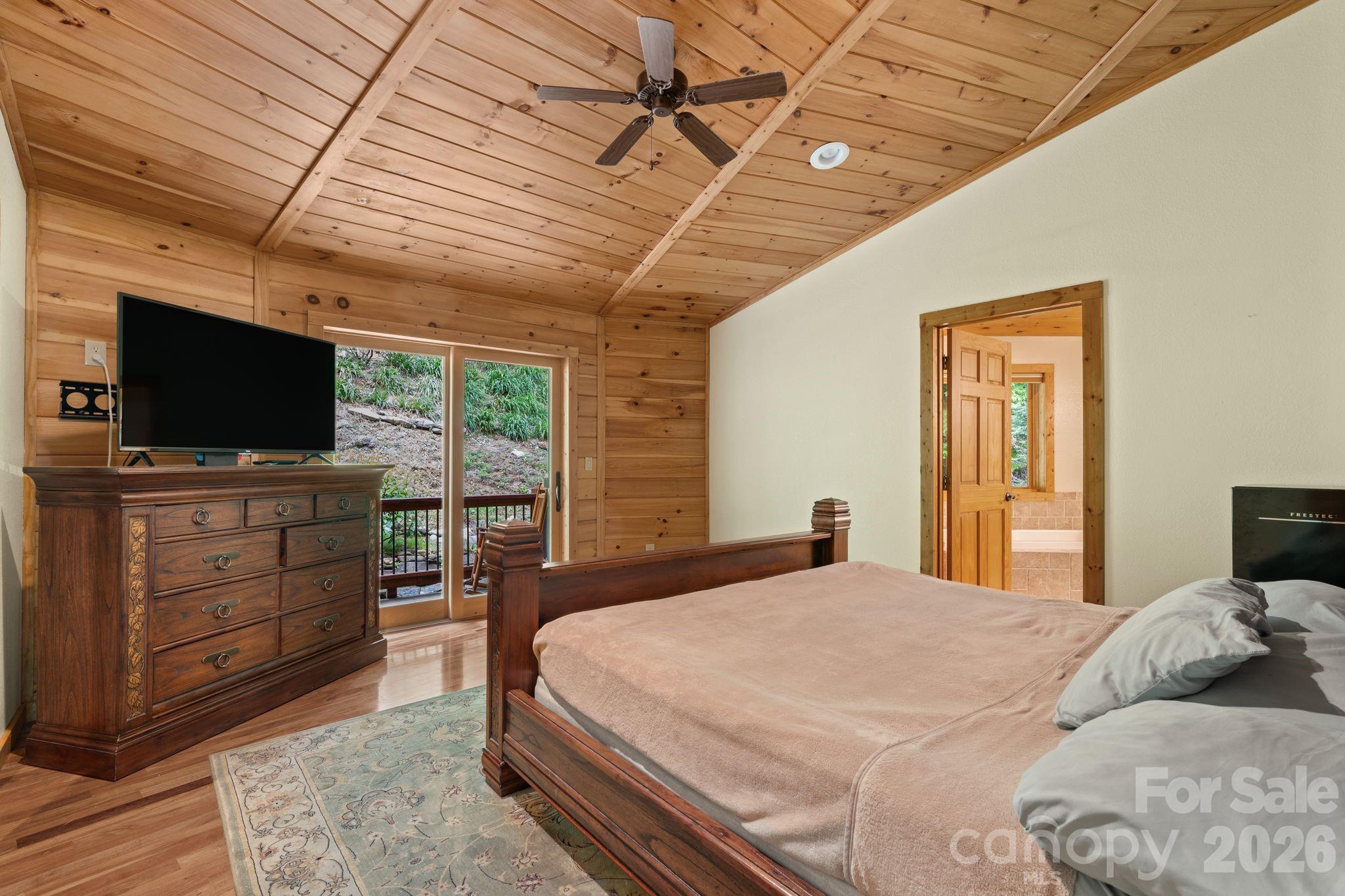 140 Slim Ridge Maggie Valley, NC 28751 - Photo 9 of 33 a bedroom with a bed and flat screen tv