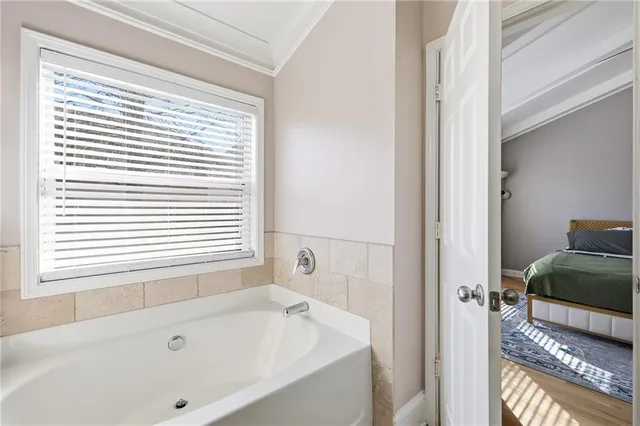 a bathroom with a tub and a window
