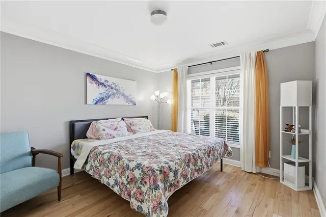 a bedroom with a bed and a large window