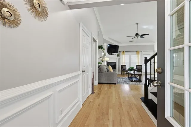 a view of a living room with furniture and wooden floor