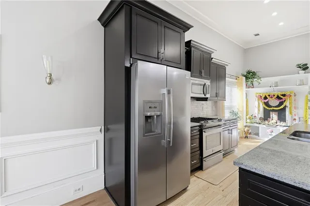 a kitchen with stainless steel appliances a refrigerator stove and sink