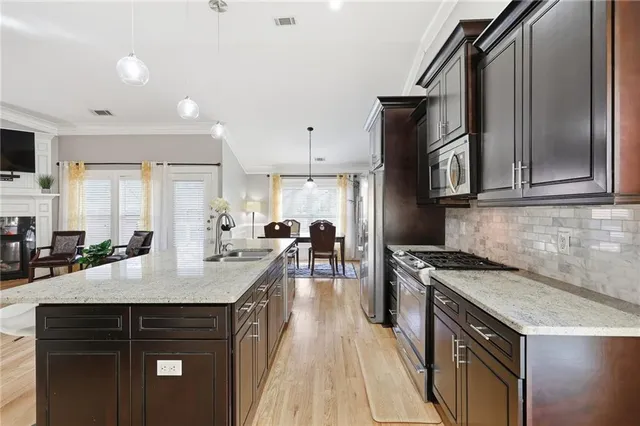 a kitchen with a sink stove and cabinets