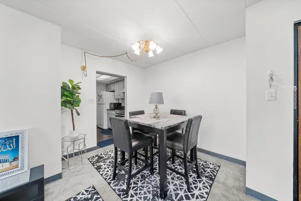 a view of a dining room with furniture and chandelier