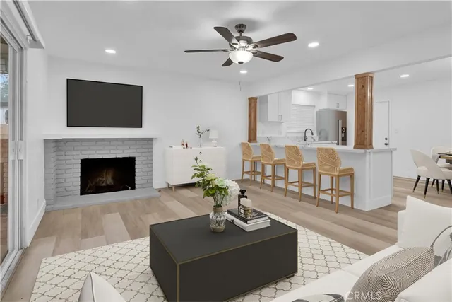 a living room with furniture a flat screen tv and a fireplace