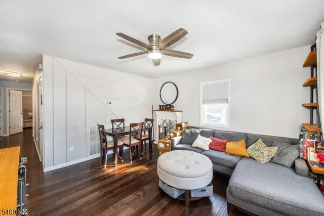 a living room with furniture a dining table and wooden floor