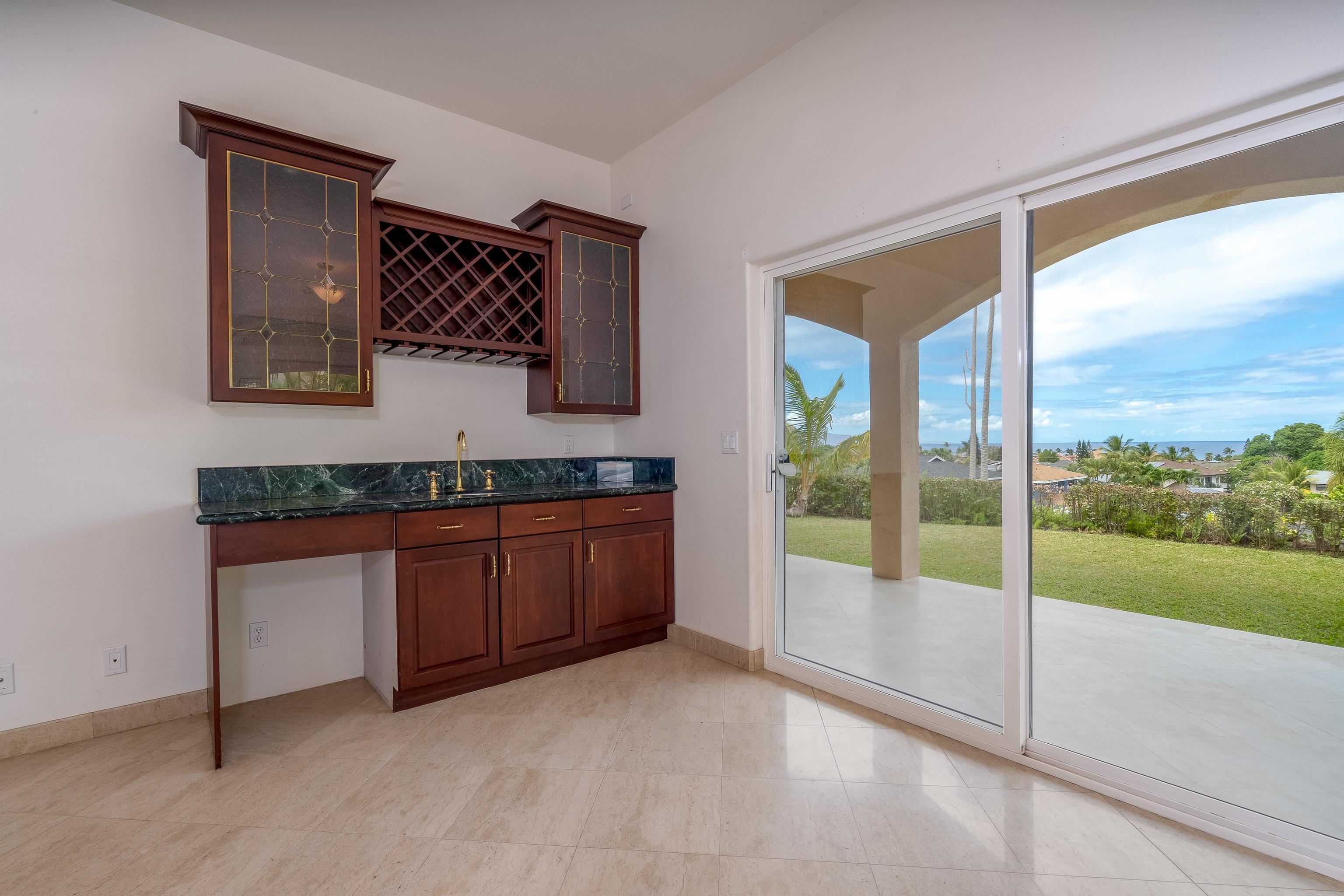 216 Kamakoi Loop Kihei, HI 96753 - Photo 13 of 30 a view of a kitchen with a sink and dishwasher with a large window