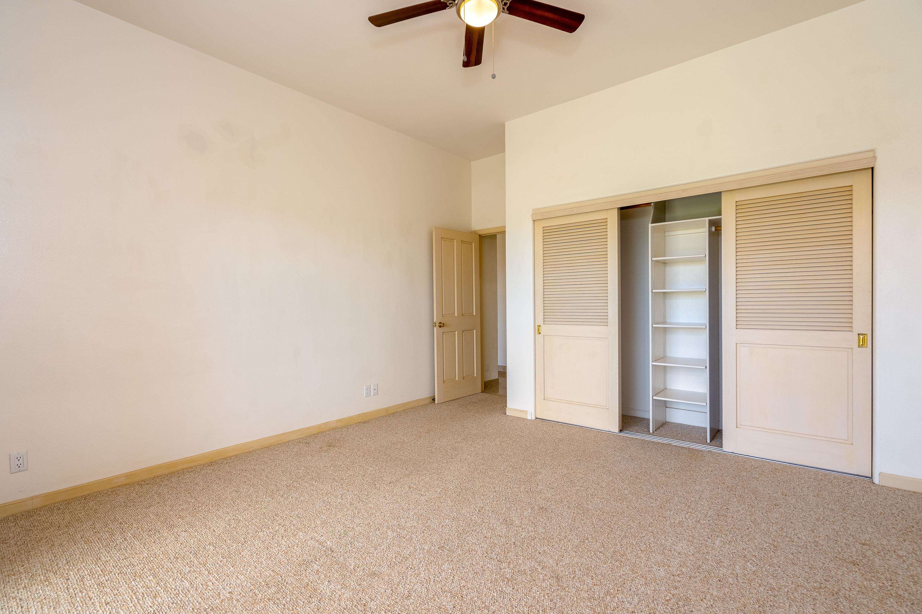 216 Kamakoi Loop Kihei, HI 96753 - Photo 16 of 30 an empty room with a ceiling fan and window