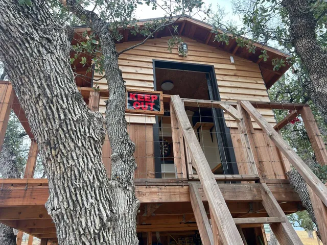 a front view of a house with iron fence