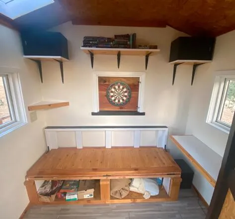 a bed sitting in a bedroom next to a window