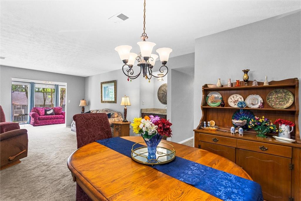 1610 Raleigh Circle Marietta, GA 30067 - Photo 11 of 33 a living room filled with furniture and a chandelier