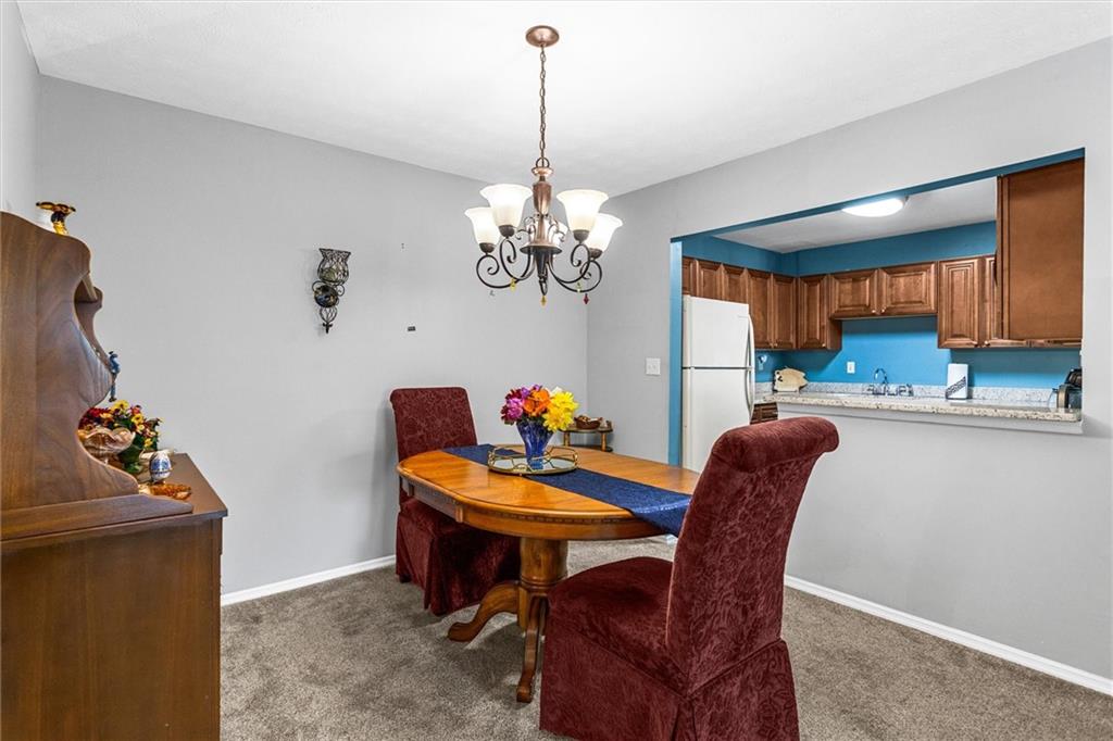 1610 Raleigh Circle Marietta, GA 30067 - Photo 12 of 33 a dining room filled chandelier and furniture